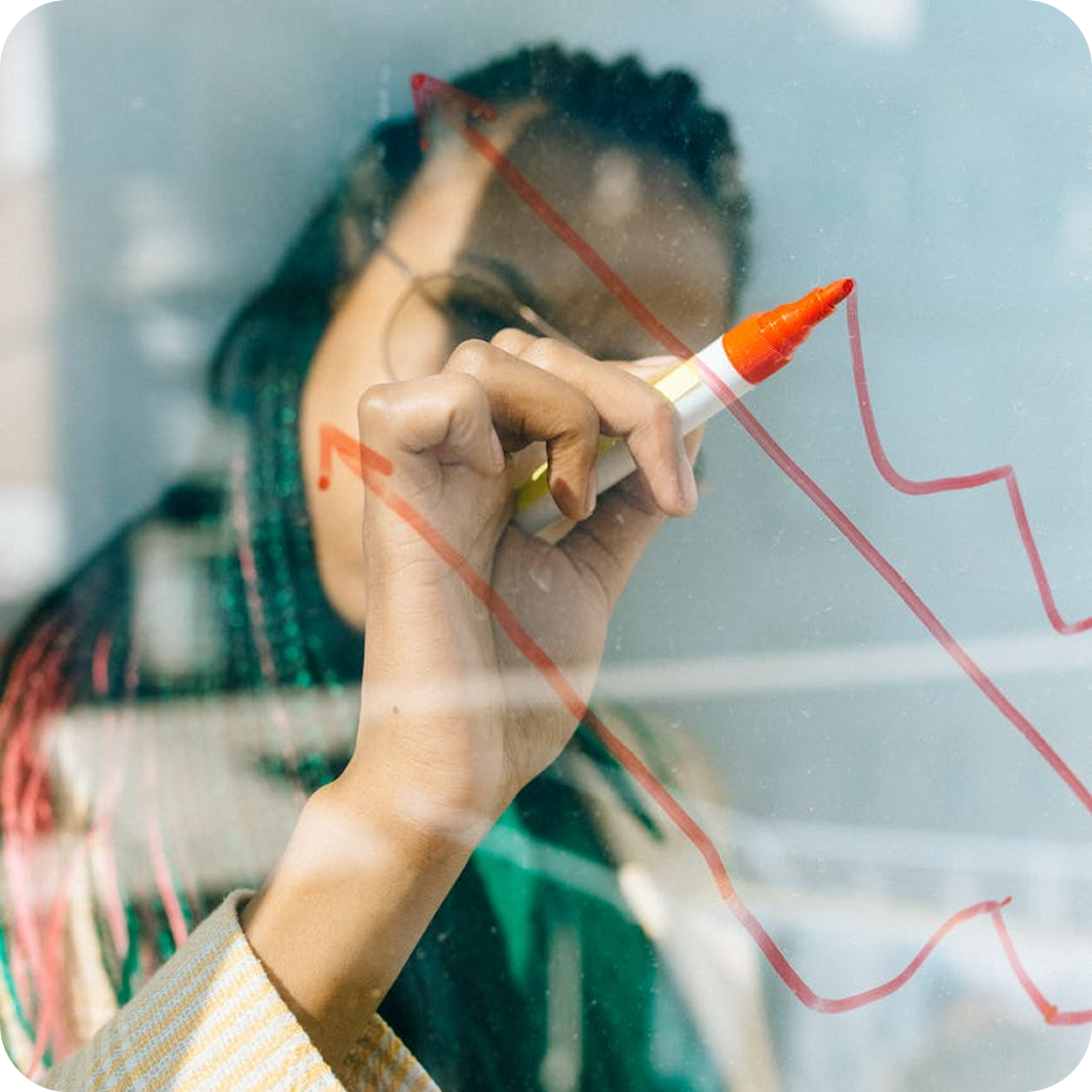 Businesswoman drawing digital architecture diagram on glass board for strategy planning