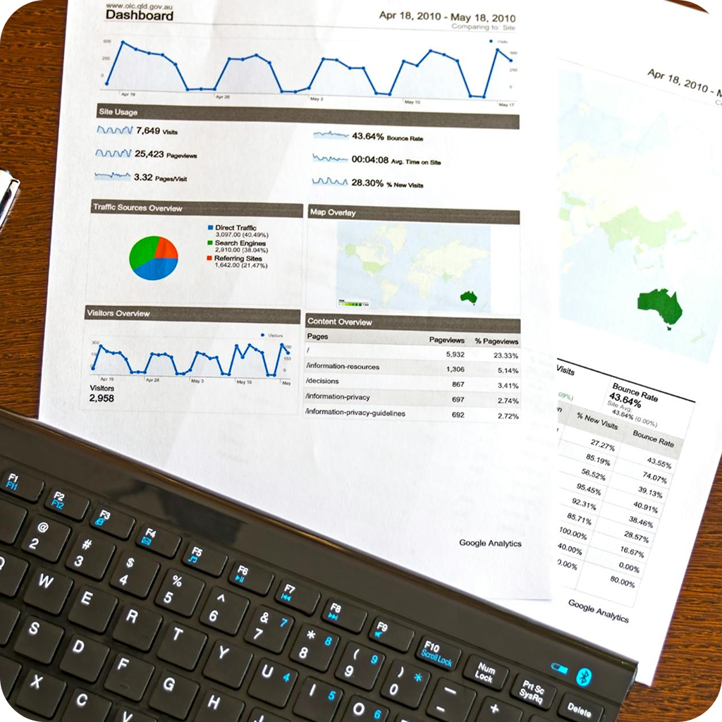 Printed analytics and system reports placed on keyboard during data integration audit